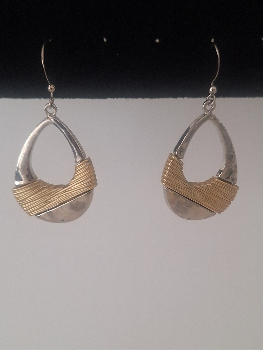 Silver tone earrings with gold tone accents